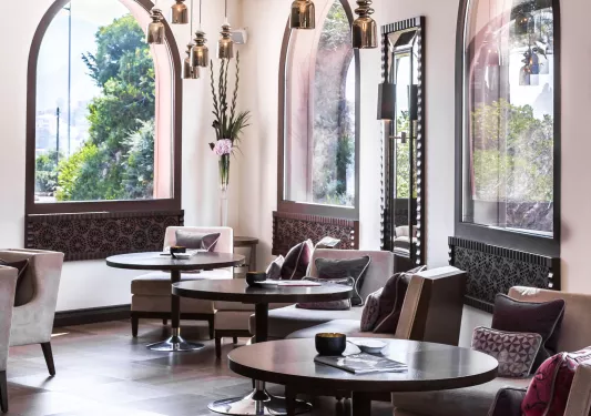 Hotel lobby with circular tables and cushioned chairs
