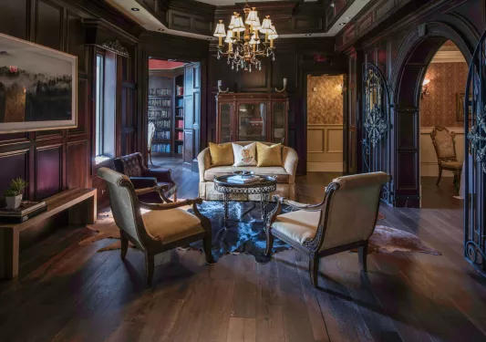 Large room with cushioned chairs and paintings on the walls