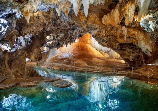 Cave with white crystals and blue water