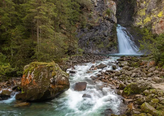 Waterfall and river flowing through large boulders