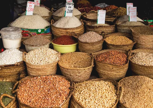 Merchant stall with beans and lentils in large, woven baskets