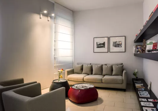 Living room seating area with gray couches and warm lights