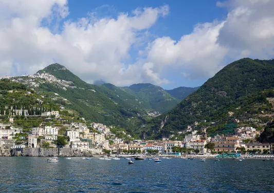 Wide view of large mountains and a coastal town