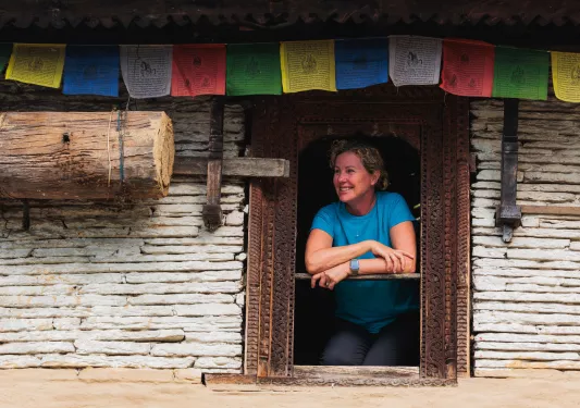 Woman leaning out a window while smiling