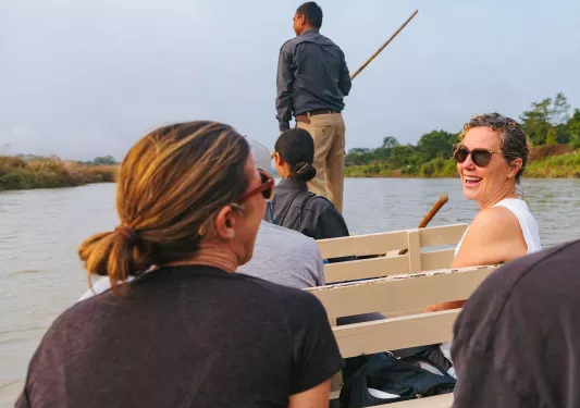 Group of women smiling while riding on a boat