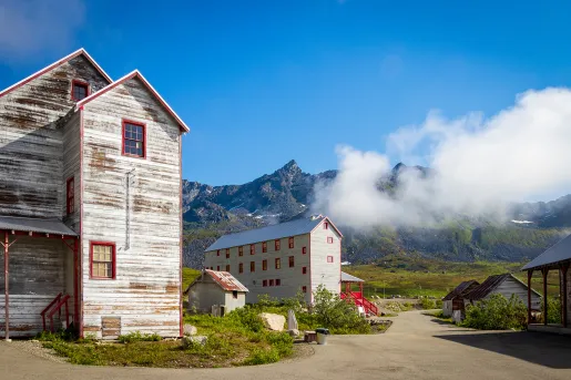 Wood sided buildings next to a mountain in Alaska