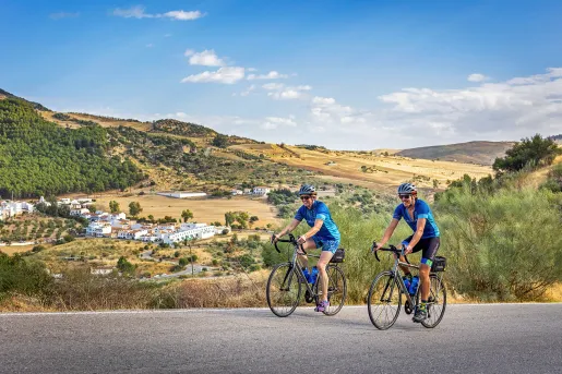 Two bikers riding on a road in southern Spain.