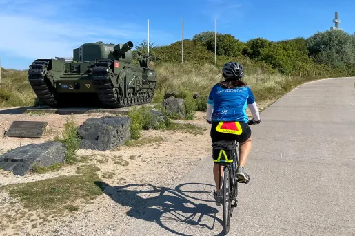 Backroads Guest Biking Past Army tank