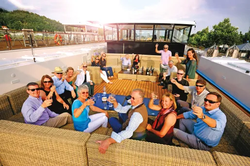 Group of Backroads' guests having happy hour aboard a ship.