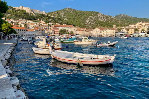 Coastal town and houses, boats scattered about.