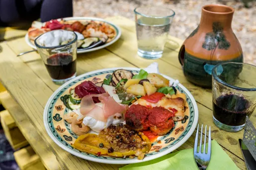 Platter of food, cheese, cured meats, meatballs, fruits, etc.