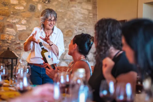 Four guests at dinner, talking wine with local.