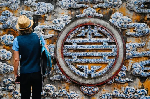 Guest in front of large painted longevity symbol.