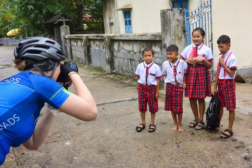 Guest/leader taking photo of four young locals. 