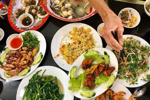 Spread of Vietnamese food, fried rice, meat, seafood, veggies, etc.