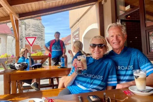 Bikers preparing for a bike ride over morning coffee and pastries.
