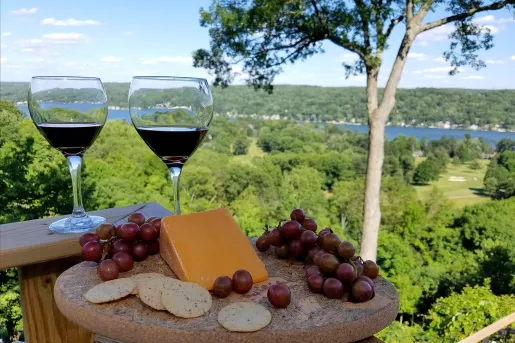 Shot of small charcuterie platter and two wine glasses.