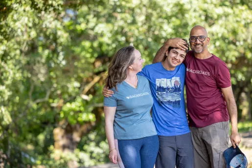 Three Backroads guests hugging, posing for photo.