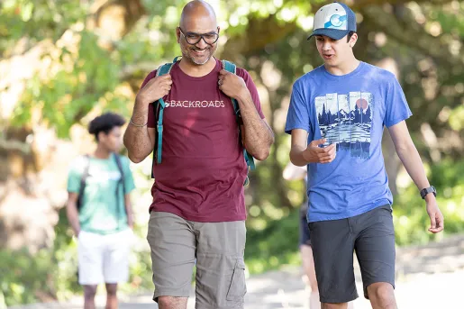 Father and son hiking through a forest