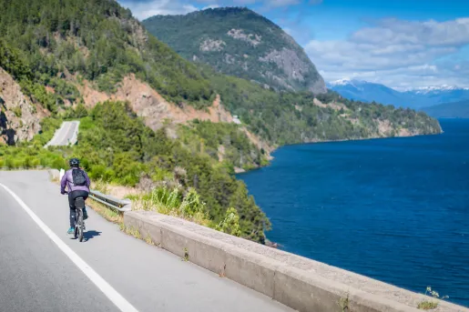Solo biker riding along a lake in Argentina