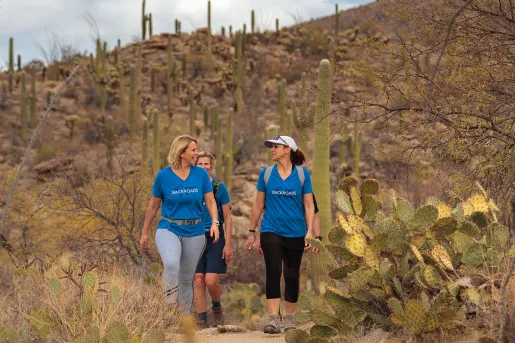 Women hikers in blue backroads shirts talking 