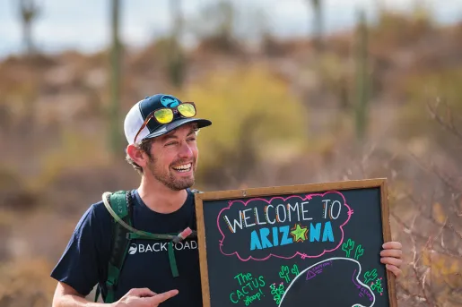 Leader holding a welcome to Arizona sign