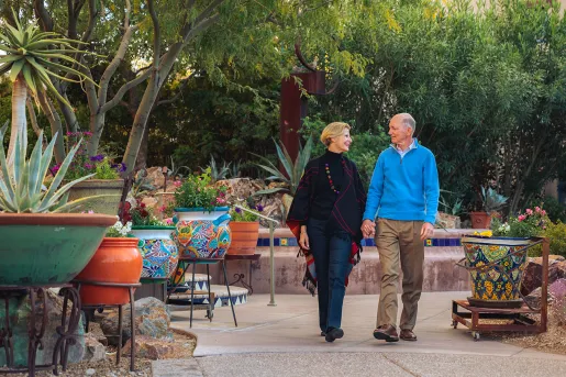 Couple holding hands walking in patio AZ
