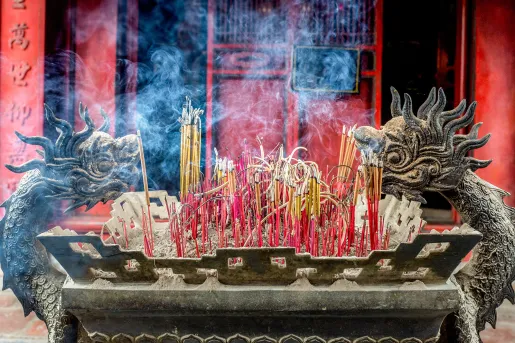 Incense burning in a dragon shaped shrine in Vietnam
