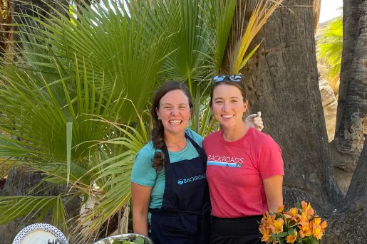 Guest and leader with prepped lunch spread.