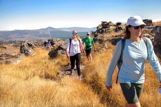 Hikers smiling along trail in Africa