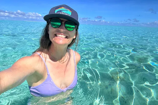 Woman swimming in crystal clear waters in Tahiti
