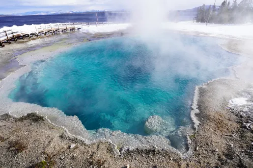 Hot spring surrounded by snowy ground