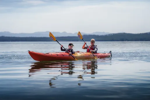 Backroads guests canoeing through blue water