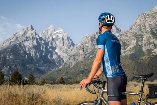 Backroads guest stopping on bike to appreciate mountains