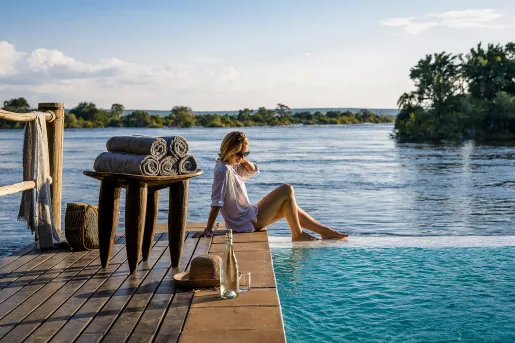 Woman with her feet in the water at Sanctuary Sussi & Chuma