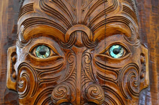 Carved face in Maori style, New Zealand