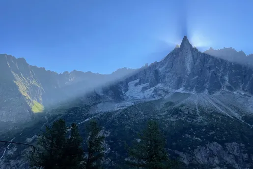 Shot of large mountain eclipsing sun, camera is in shadow.