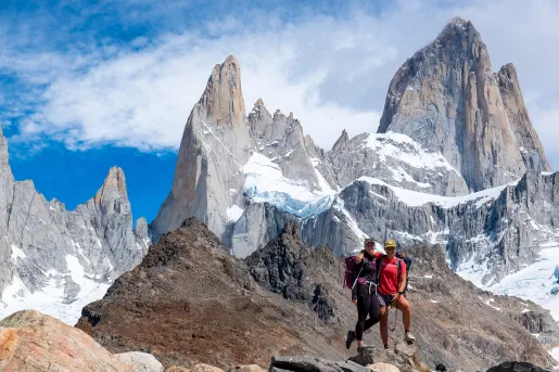Two hikers posing on top of a rock in Patagonia.