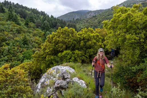 Backroads hiker on trail in dense wilderness in Greece.