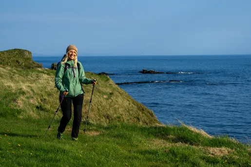 Hiker posing on a rock, clifside.