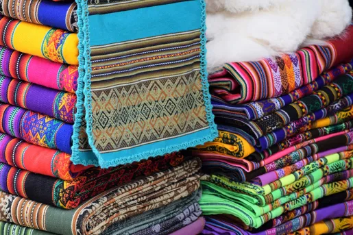 Colorful pile of textiles, numerous different patterns and colors.