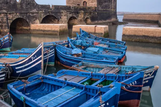 Port of Essaouira, blue scows docked in foreground