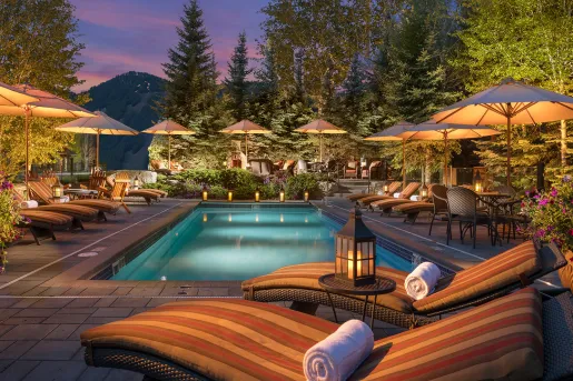 Exterior view of Rustic Inn Resort pool at night.