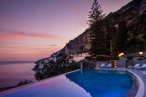 infinity pool looking out over sunset over the amalfi coast