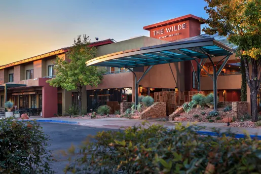 Exterior view of hotel building with stone accents and glass doors