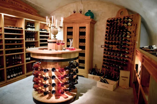 Wine cellar with wooden shelves full of wine bottles
