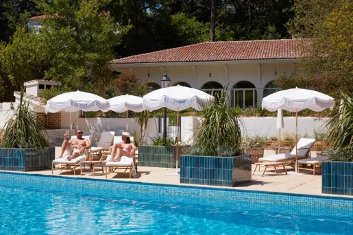 guests lounge by the pool