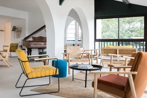 multi color chairs surrounding a coffee table