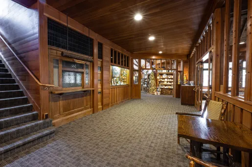 Lodge wooden interior with skylights leading to a store