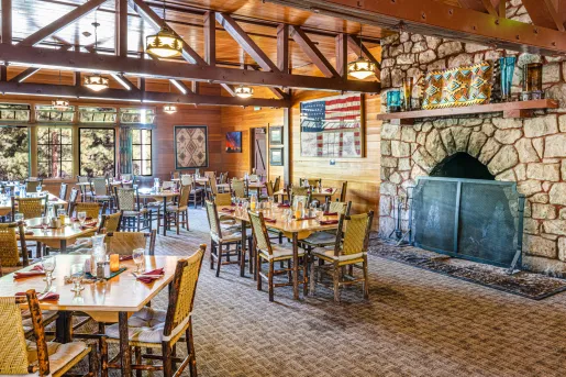Dining room with a stove fireplace and tables and chairs